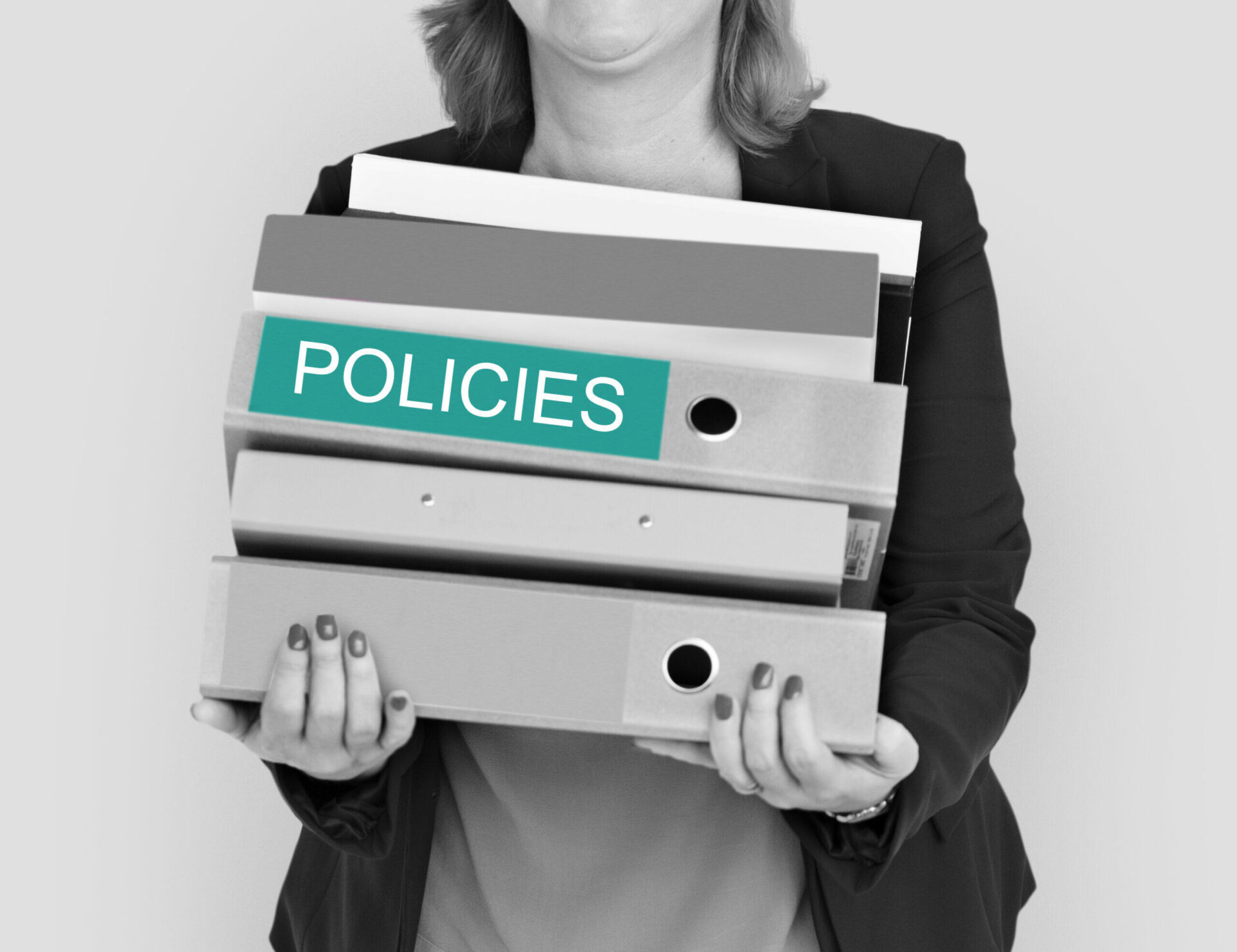 Woman holding files labeled "POLICIES," relevant to ACNC Governance Standard 6 and the National Redress Scheme.