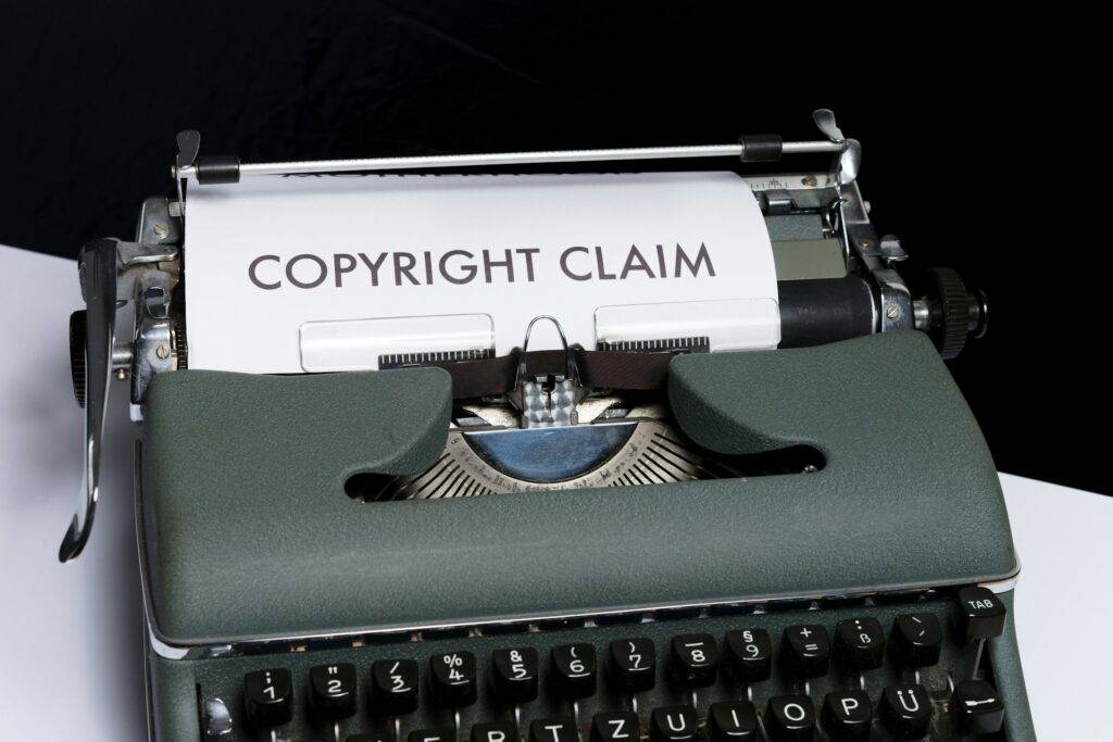 Vintage typewriter with "COPYRIGHT CLAIM" typed on the page. Protecting your NFP's intellectual property.