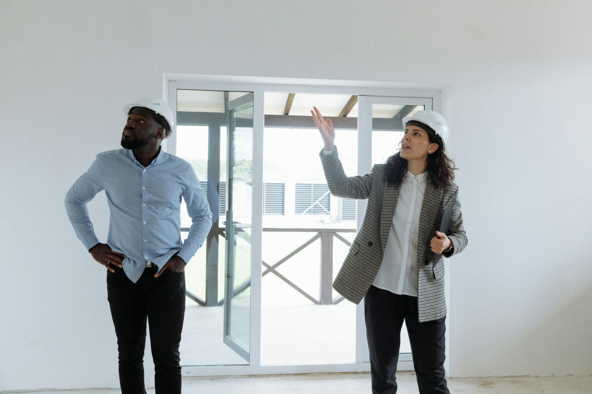 Two architects in hard hats review plans at a NSW development site, conducting advanced due diligence.
