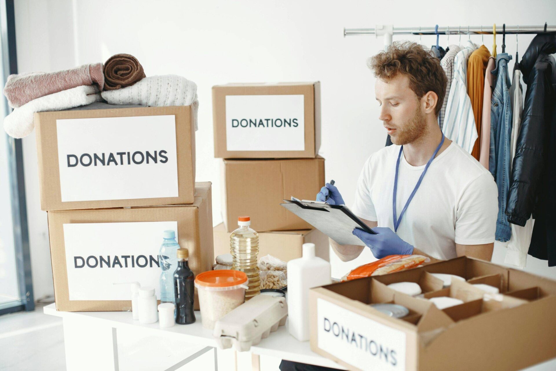 Volunteer sorting donations for an Australian charity, including boxes labeled "DONATIONS