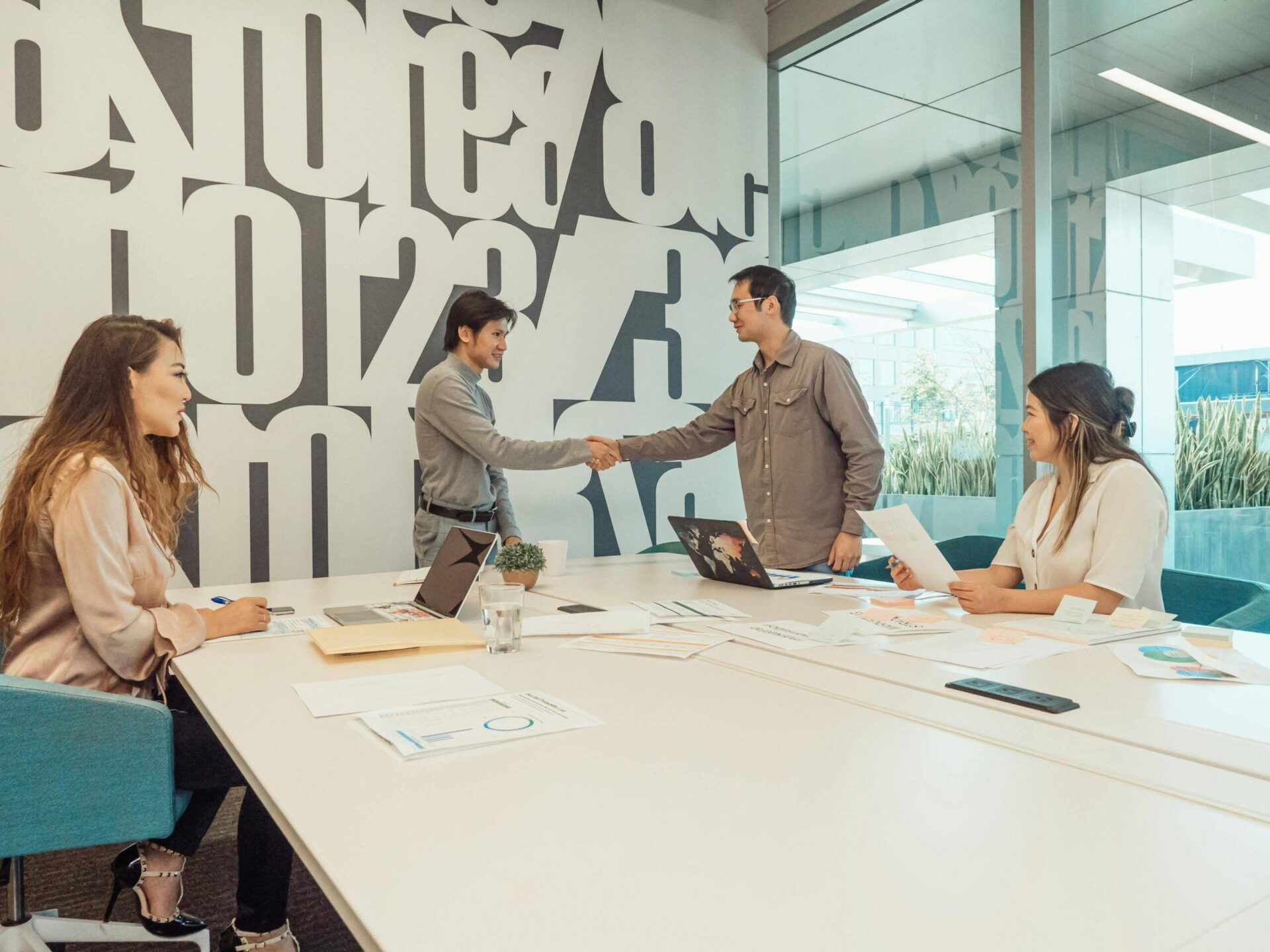Business team shaking hands at a meeting, discussing NFP governance.