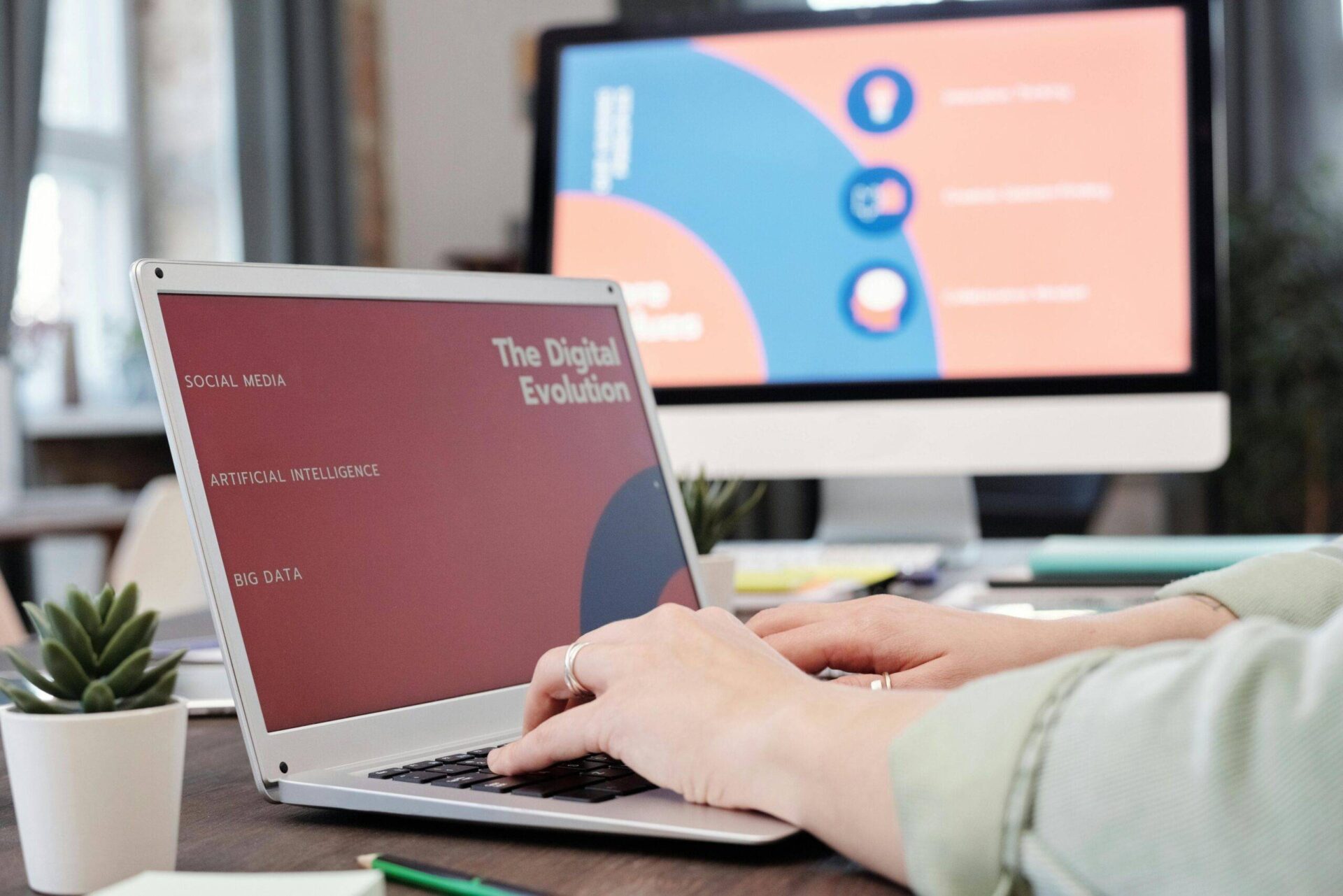 Person typing on laptop with "The Digital Evolution" displayed, featuring keywords like Social Media and Artificial Intelligence.