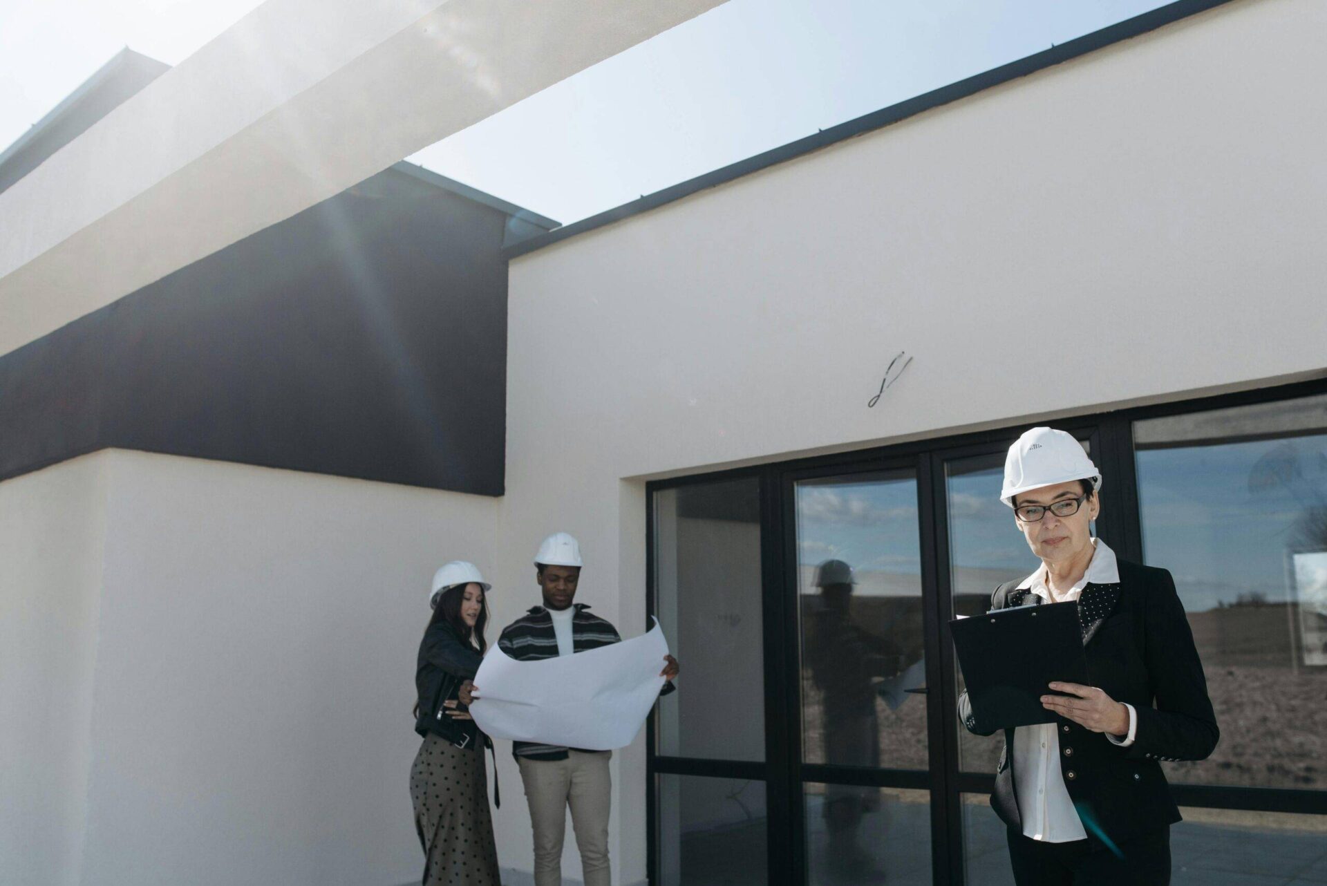 Architect reviewing blueprints on a new construction site, focusing on due diligence. NSW development.