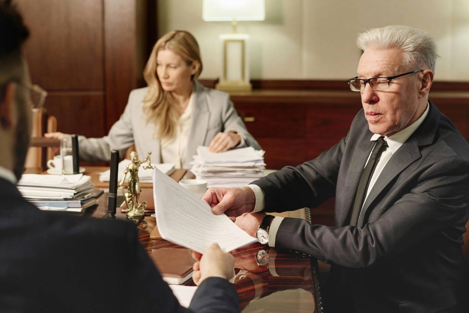 Lawyers reviewing documents, possibly related to PBI status defense after the "Equality Australia" decision.