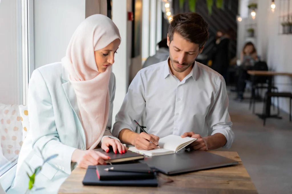 Islamic probate lawyer assisting a client with estate planning in a bright office setting.