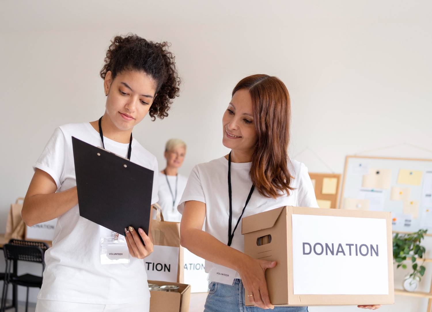 Volunteers with "Donation" boxes and clipboard. Data breach litigation risk support.