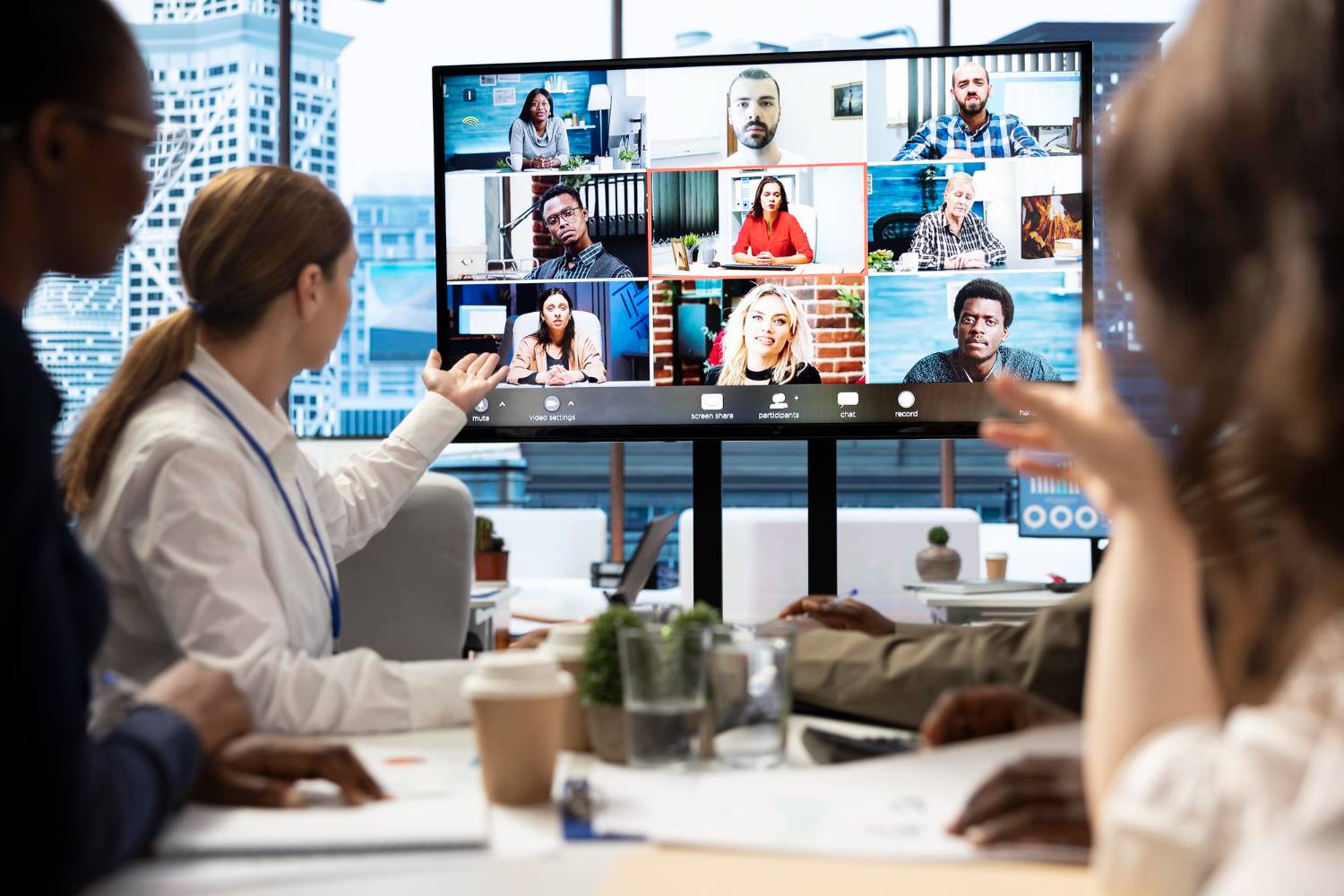 Virtual meeting on screen with in-person attendees. Legal risks for charities.