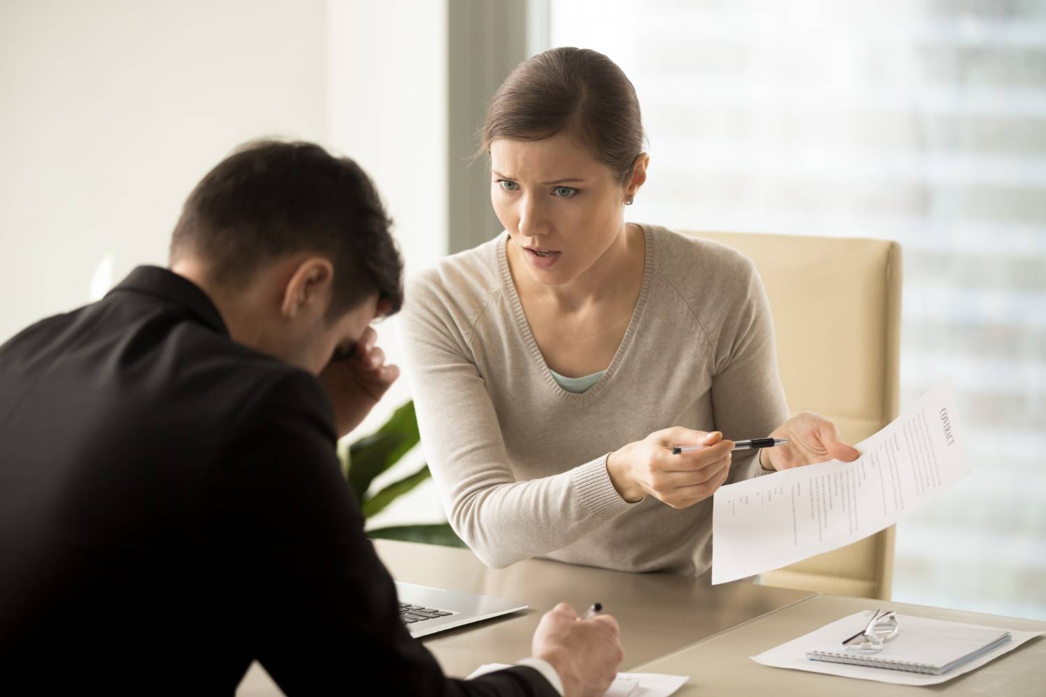 Woman confronts man over contract, conflict of interest.