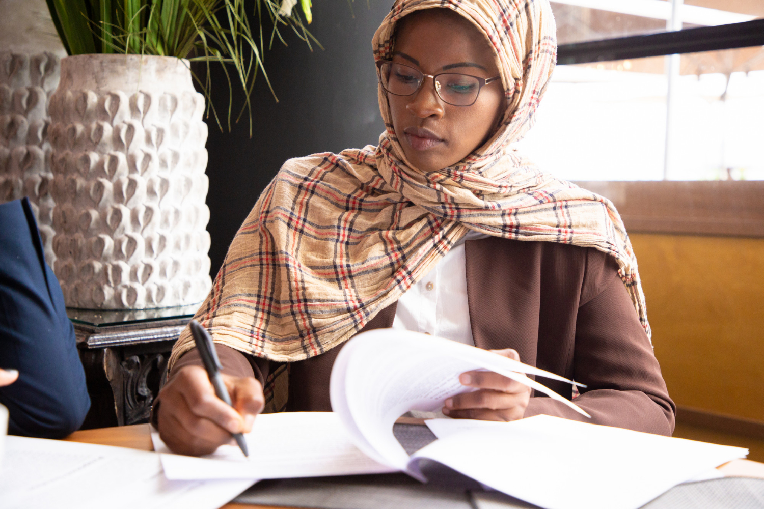 Woman in hijab reviewing documents for Islamic estates in NSW