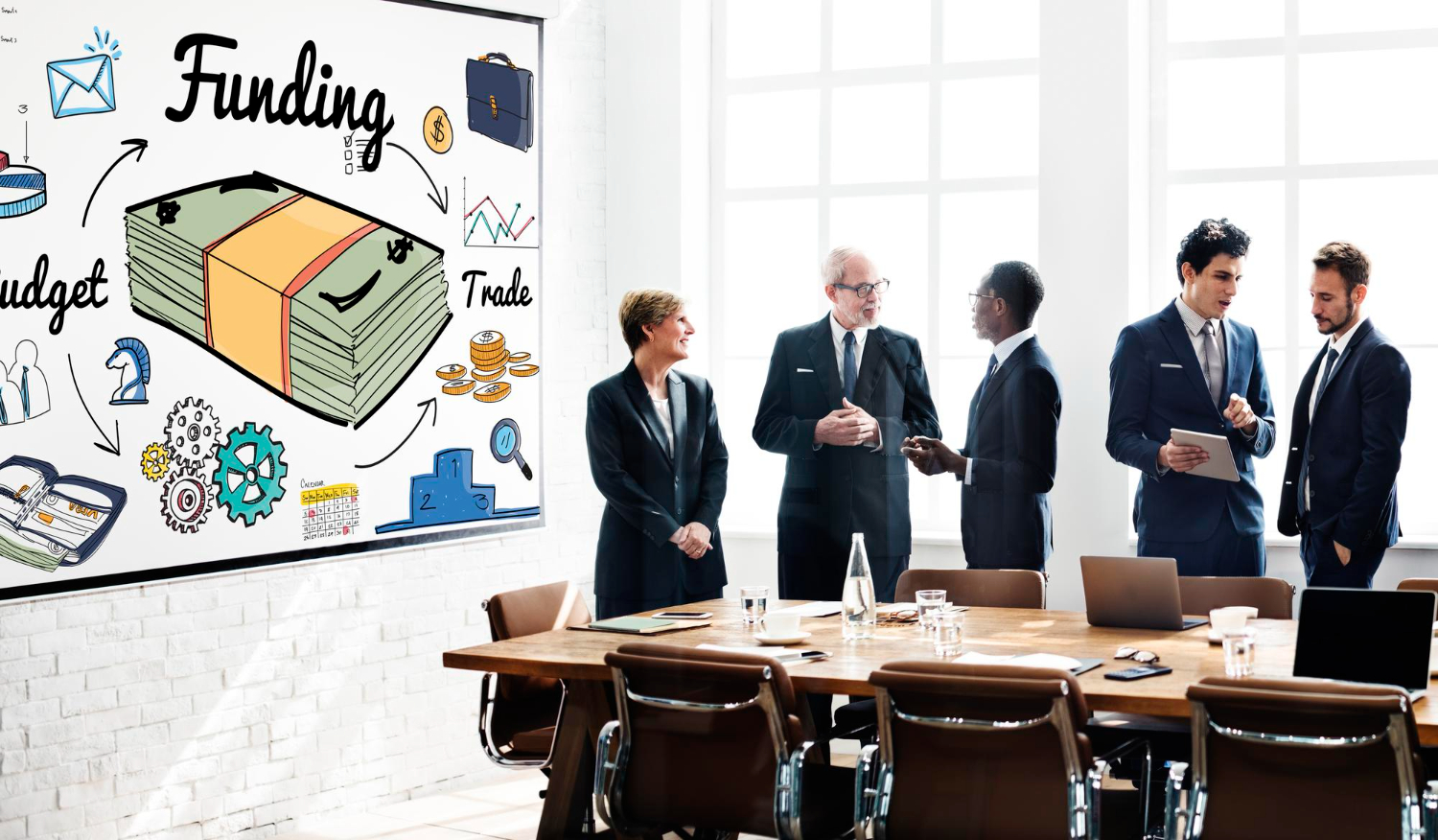 Business meeting discussing funding and budget, with a whiteboard illustrating money and trade.