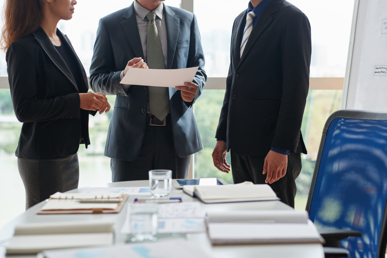 Business professionals discussing legal documents, possibly related to NSW intestacy laws.