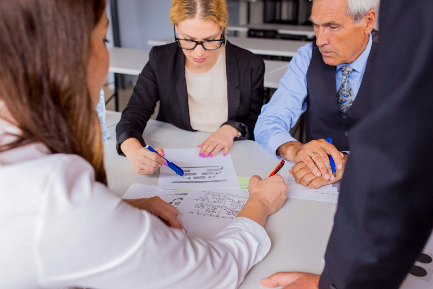 Business meeting discussing documents, potential assets for probate in NSW.