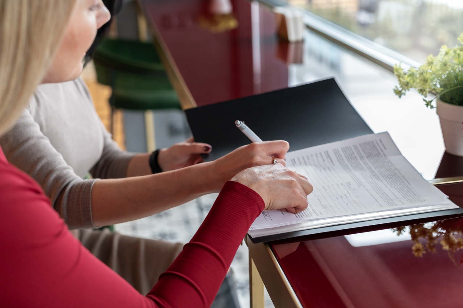 Two women reviewing legal documents for Letters of Administration in NSW