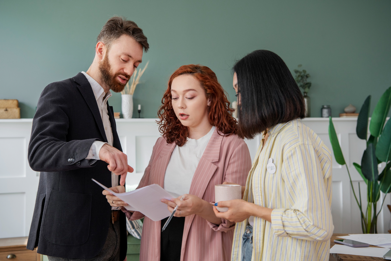 Three professionals discuss documents, possibly related to NSW estate disputes.