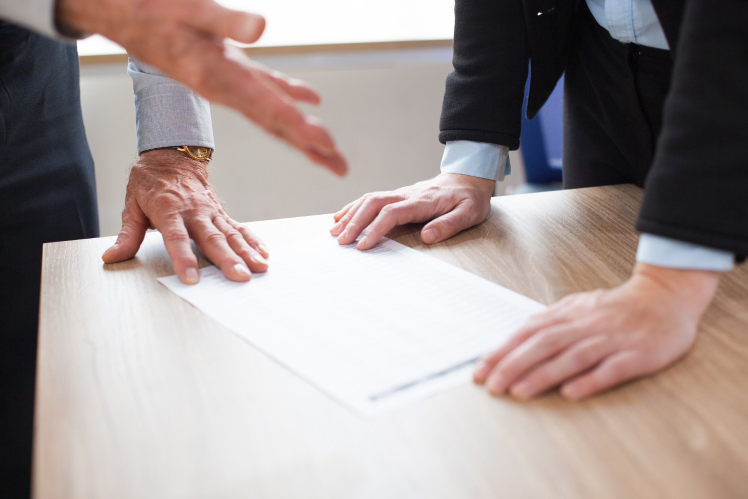 Two individuals reviewing a document, discussing estate disputes.