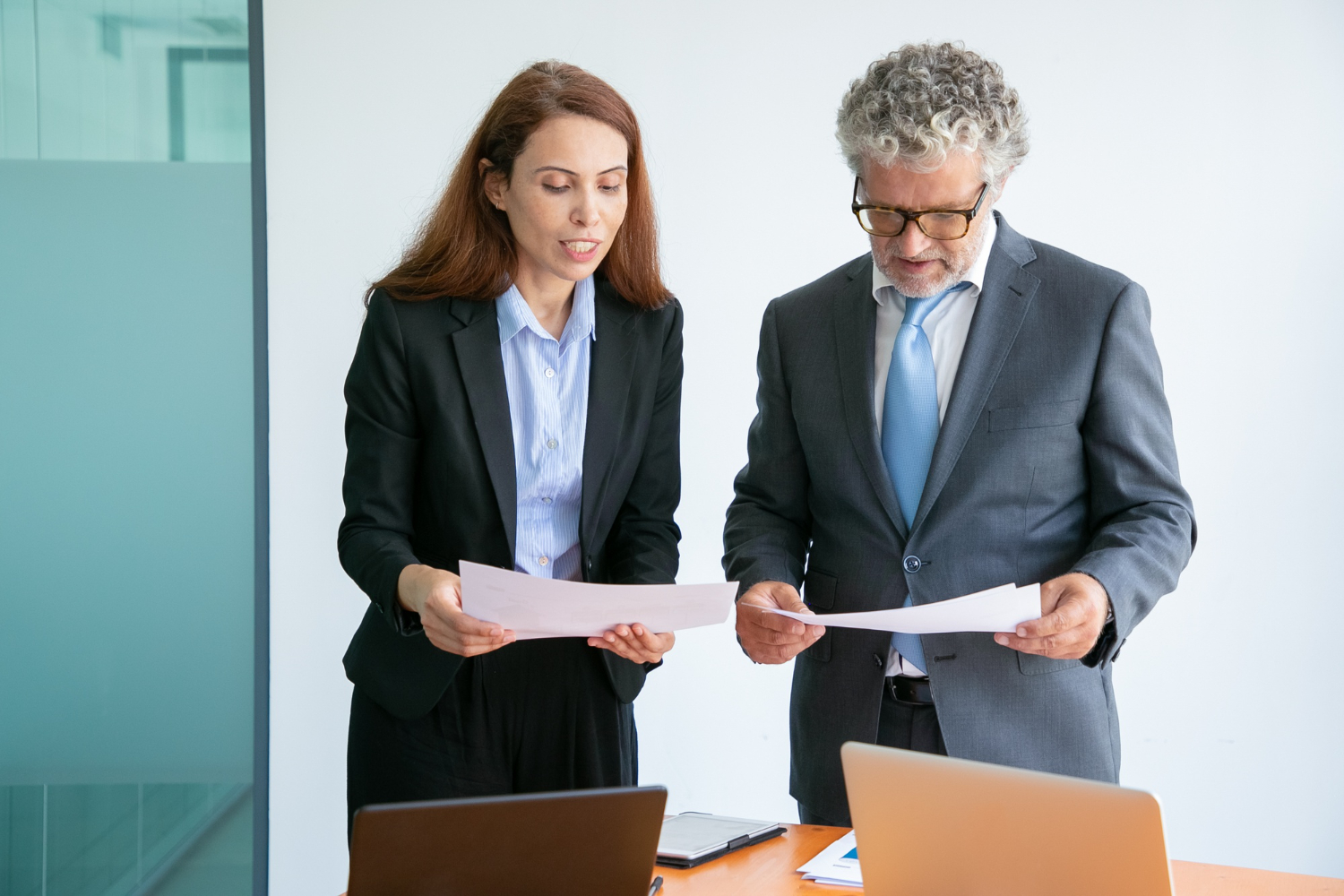 Business professionals discuss documents, potentially related to probate or letters of administration in NSW.
